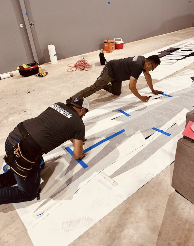 workers working on getting signage ready for installation